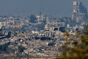 Buildings lie in ruin in Gaza, amid the ongoing conflict between Israel and the Palestinian Islamist group Hamas, as seen from southern Israel, December 4, 2023.