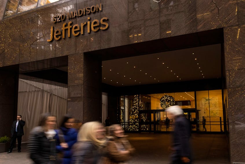 People walk outside of Jefferies Financial Group offices in Manhattan, New York, U.S., December 8, 2021.