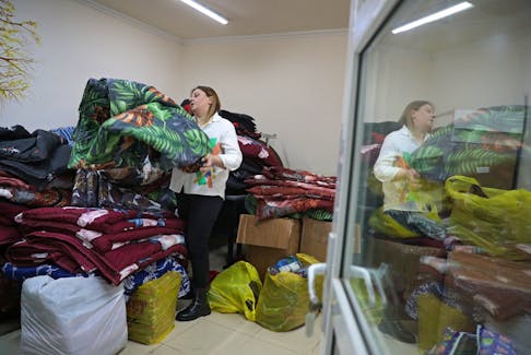 Lilia Abrahamian, a charity worker, shows blankets prepared for refugees from Nagorno-Karabakh region, in the city of Vanadzor, Armenia November 23, 2023.