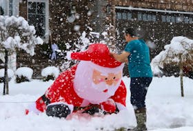 An Astral Drive resident pulls up a an inflatable Santa Claus that had collapsed from the heavy snow, on Colby Village in Dartmouth December 4, 2023.

TIM KROCHAK PHOTO