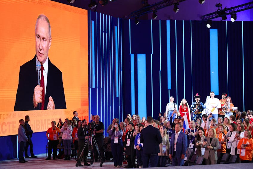 Participants listen to Russian President Vladimir Putin, who delivers a speech during a ceremony awarding the prize winners of a civic engagement forum in Moscow, Russia, December 4, 2023. Sputnik/Mikhail Klimentyev/Pool via REUTERS