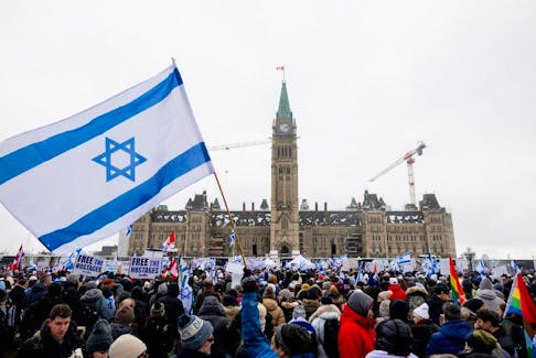 On Parliament Hill Monday, Israeli flags and signs featuring slogans such as "Free the hostages," "Blame Hamas, not Israel" and “Jewish lives matter” dotted the landscape as a dozen speakers denounced rising antisemitism and anti-Israel sentiment. 