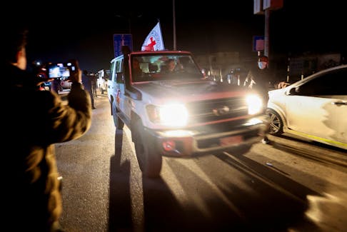 A Red Cross vehicle, as part of a convoy carrying hostages abducted by Hamas militants during the October 7 attack on Israel, arrives at the Rafah border, amid a hostages-prisoners swap deal between Hamas and Israel, in the southern Gaza Strip, November 30, 2023.
