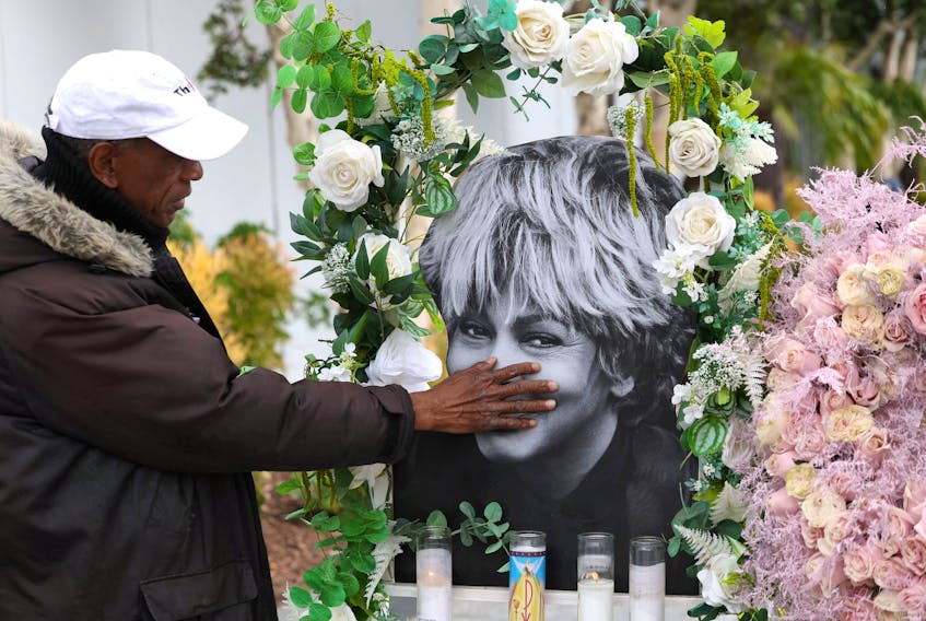Donnie Green touches a photograph of late singer Tina Turner placed near her star on the Hollywood Walk of Fame in Los Angeles, California, U.S., May 25, 2023.