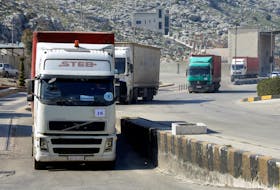 A convoy of trucks carrying aid from UN World Food Programme (WFP), following a deadly earthquake, enters Bab al-Hawa crossing, Syria February 20, 2023. 