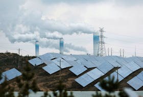 Smoke rises from chimneys near solar panels, during a Huawei-organised media tour, in Shaanxi province, China April 24, 2023.