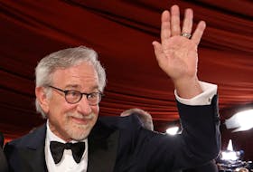 Steven Spielberg waves on the champagne-colored red carpet during the Oscars arrivals at the 95th Academy Awards in Hollywood, Los Angeles, California, U.S., March 12, 2023.