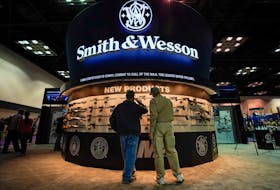 Attendees inspect Smith and Wesson firearms at the National Rifle Association's (NRA) annual meeting, in Indianapolis, Indiana, U.S., April 28, 2019. 