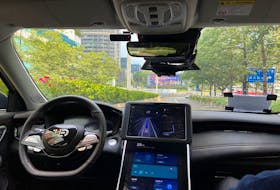 A safety driver sits on the passenger seat as the car with autonomous driving system by DeepRoute.ai, drives itself on a street in Shenzhen, Guangdong province, China July 29, 2022.