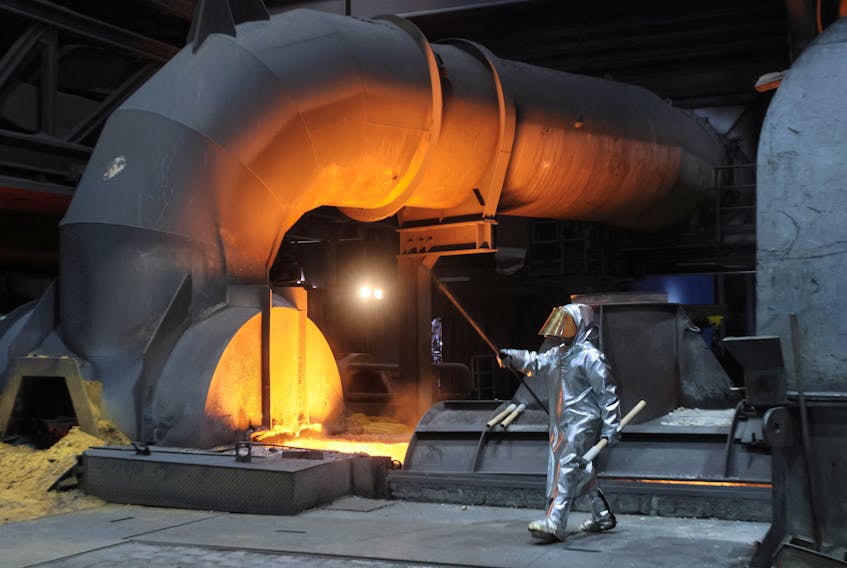 A steel worker of ThyssenKrupp walks in front of a blast furnace at a ThyssenKrupp steel factory in Duisburg, western Germany, November 14, 2022.
