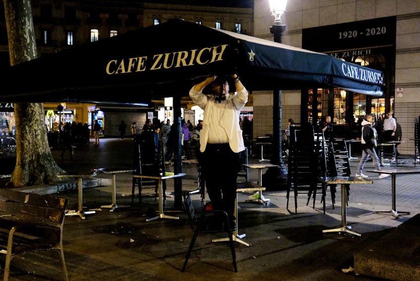 A waiter picks up the terrace of the Zurich bar at Placa de Catalunya in Barcelona, Spain April 4, 2023.