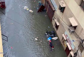 Scooters are partially submerged on a flooded street following heavy rains ahead of Cyclone Michaung in Chennai, Tamil Nadu, India December 4, 2023 in this still image obtained from social media. Chetna Vinay Bhora/via