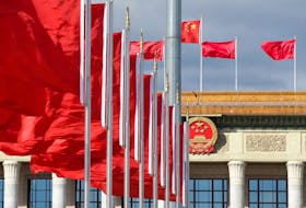 Red flags flutter in front of the Great Hall of the People in Beijing, China September 30, 2018.