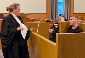 Brandon Saia speaks with his lawyer, Michelle Elliott, during a break in his trial in Newfoundland and Labrador Supreme Court in St. John's Dec. 4, 2023.