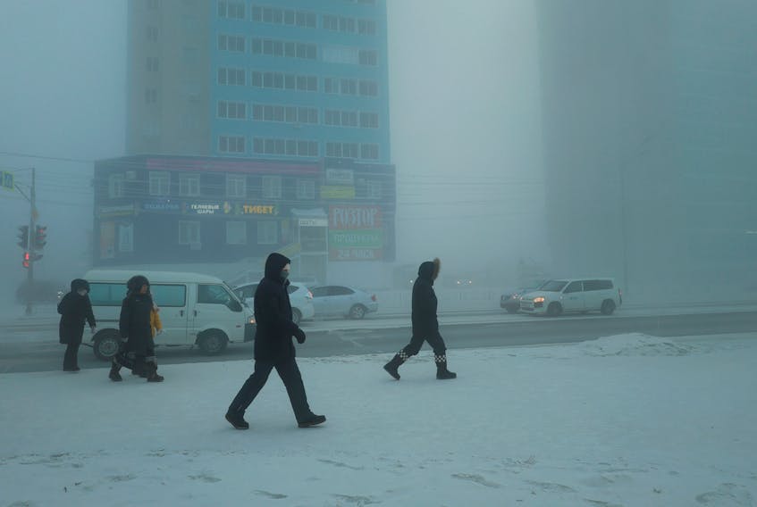 Pedestrians walk along a street on a frosty day in Yakutsk, Russia, December 5, 2023. Temperatures in parts of the Sakha Republic, also known as Yakutia and located in the northeastern part of Siberia, went below minus 50 degrees Celsius (minus 58 degrees Fahrenheit) on December 5.