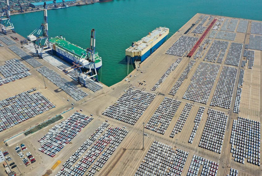 An aerial view shows cars for export at a port in Yantai, Shandong province, China May 3, 2023. China Daily via