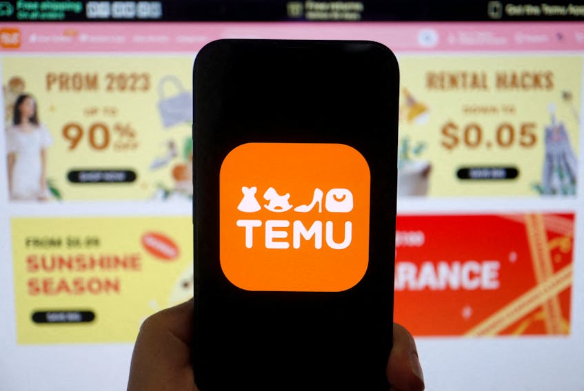 The logo of Temu, an e-commerce platform owned by PDD Holdings, is seen on a mobile phone displayed in front of its website, in this illustration picture taken April 26, 2023.
