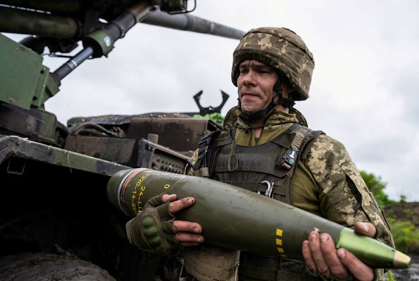 A Ukrainian service member of the 55th Separate Artillery Brigade prepare carries a shell for a Caesar self-propelled howitzer before firing towards Russian troops, amid Russia's attack on Ukraine, near the town of Avdiivka in Donetsk region, Ukraine May 31, 2023.