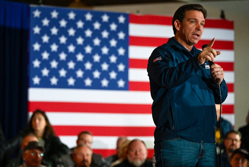 Republican presidential candidate and Florida Governor Ron DeSantis gestures as he speaks at a Never Back Down campaign event at The Thunderdome in Newton, Iowa, U.S. December 2, 2023. 