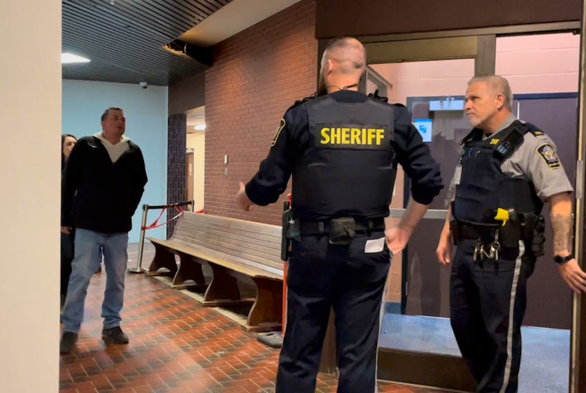 Darroll Murray Atwell heads towards the courtroom Dec. 5 with several supporters following behind. He was sentenced to 4.5 years in jail for three charges relating to crimes on May 24, 2020.