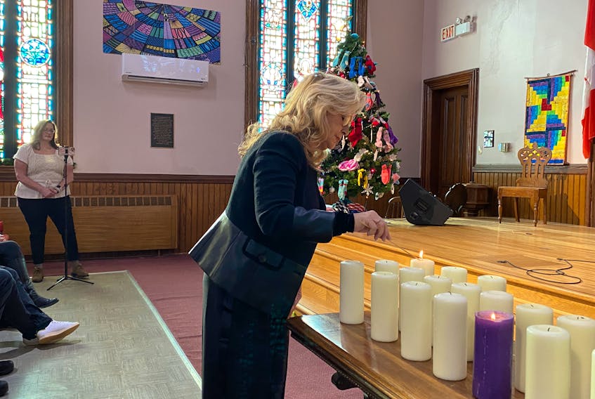 Summerside-South Drive MLA Barb Ramsay lights one of the candles at the National Day of Remembrance and Action on Violence Against Women vigil in Summerside. – Kristin Gardiner/SaltWire