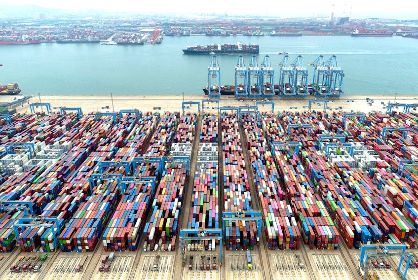 An aerial view shows containers and cargo vessels at the Qingdao port in Shandong province, China May 9, 2022. Picture taken with a drone. China Daily via