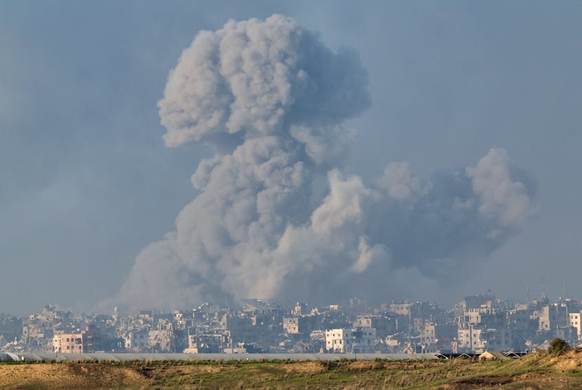 Smoke rises over destroyed buildings in Gaza, amid the ongoing conflict between Israel and the Palestinian Islamist group Hamas, as seen from southern Israel, December 6, 2023.