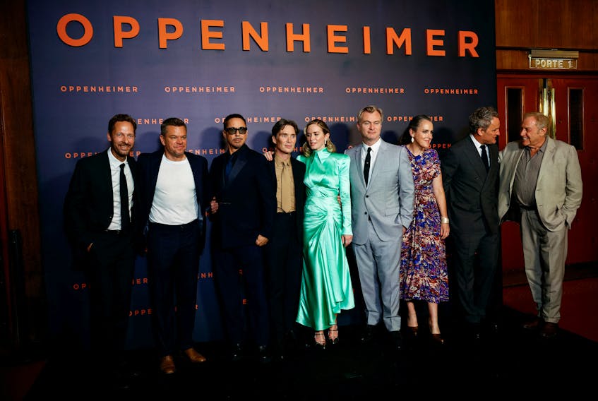 Cast members Trond Fausa Aurvag, Matt Damon, Robert Downey Jr., Cillian Murphy, Emily Blunt, Jason Clarke, Director Christopher Nolan and his wife Emma Thomas, and Producer Charles Roven pose during a photocall before the premiere of the film "Oppenheimer" at the Grand Rex in Paris, France, July 11, 2023.