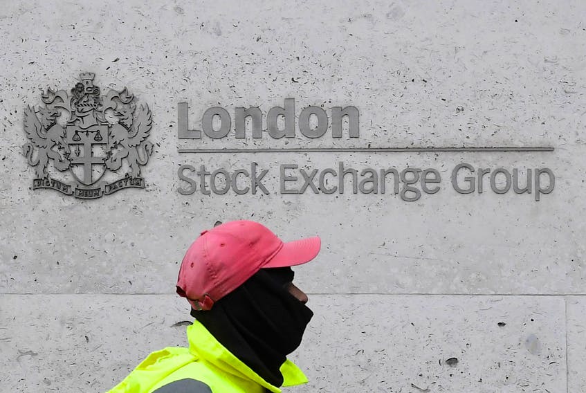 A street cleaning operative walks past the London Stock Exchange Group building in the City of London financial district, whilst British stocks tumble as investors fear that the coronavirus outbreak could stall the global economy, in London, Britain, March 9, 2020.