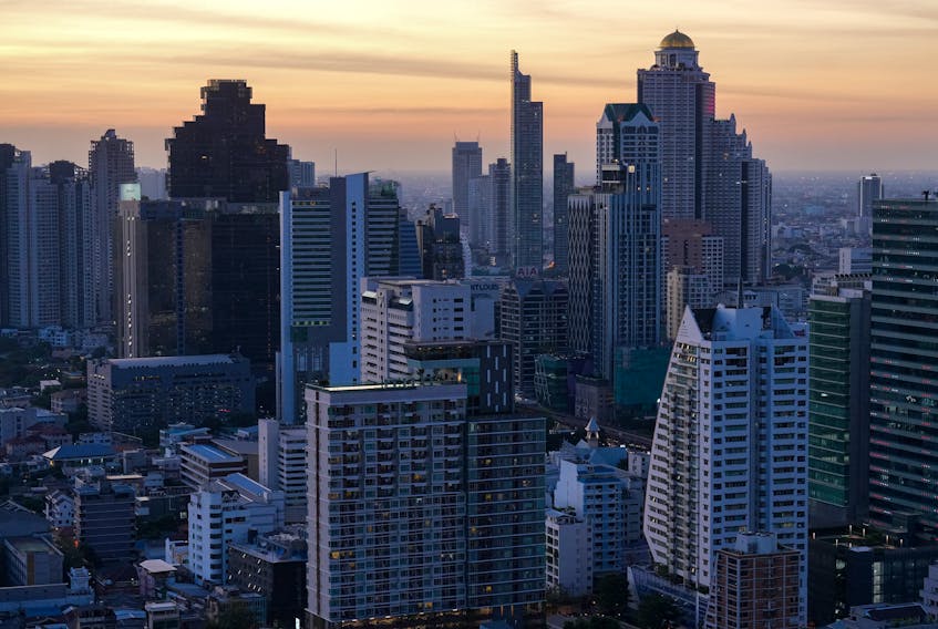 Skyscrapers are photographed against the setting sun in Bangkok, Thailand, January 4, 2023.