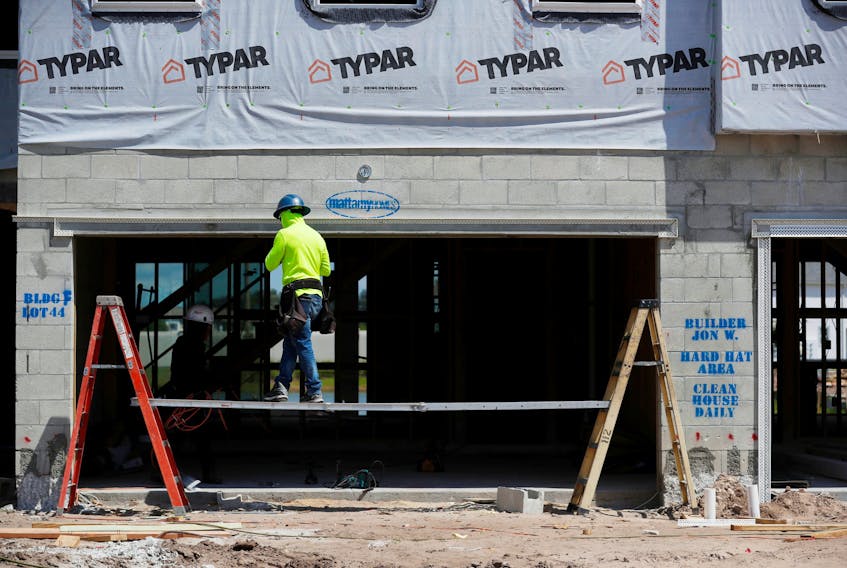 A carpenter works on building new townhomes that are still under construction while building material supplies are in high demand in Tampa, Florida, U.S., May 5, 2021. 