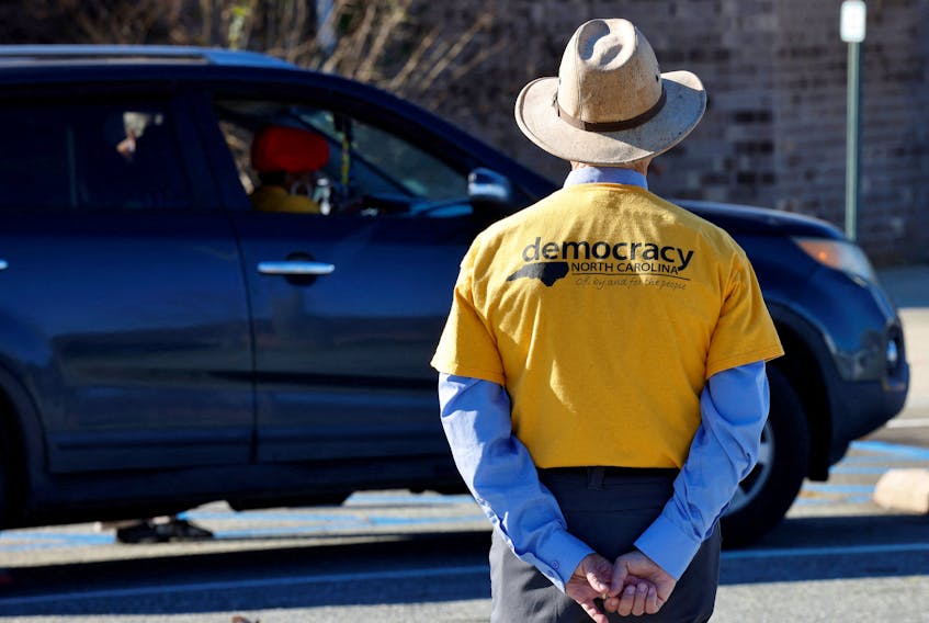 A non-partisan election observer watches curbside voting outside a polling station during the 2022 midterm elections, in Graham, North Carolina, U.S., November 8, 2022. 