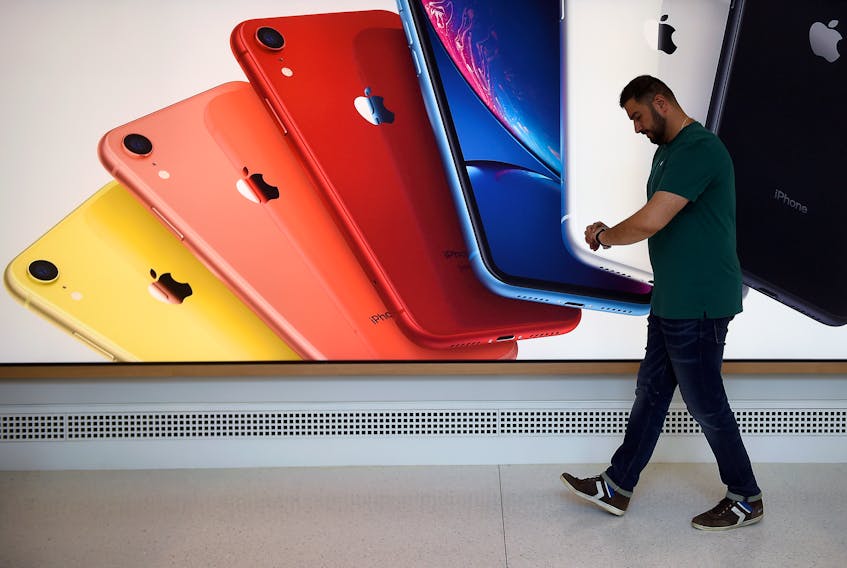 An Apple Store employee checks their Apple Watch during the grand opening and media preview of the new Apple Carnegie Library store in Washington, U.S., May 9, 2019.