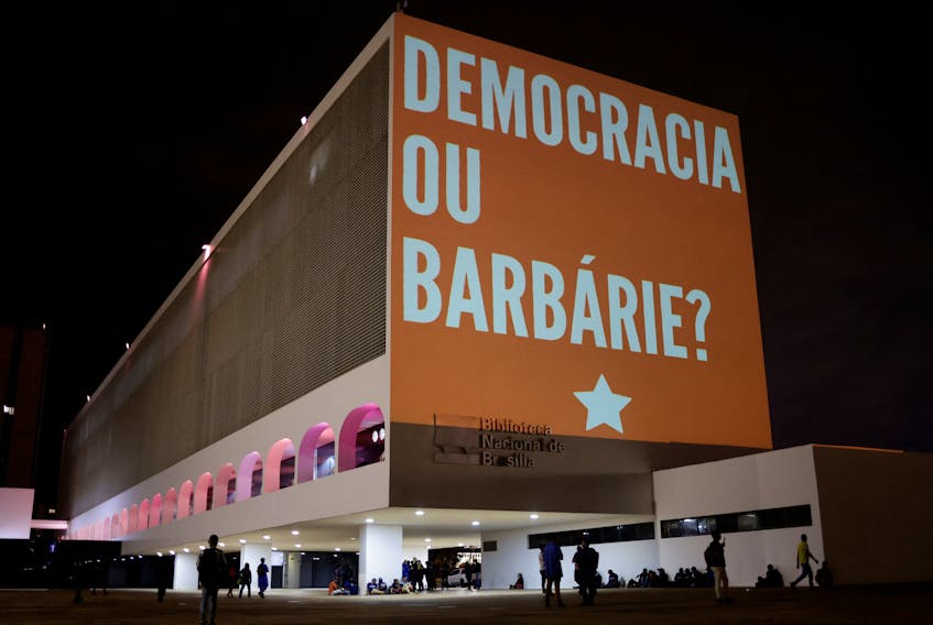 A projection on the building of the National Library of Brasilia by supporters of former Brazilian President and current presidential candidate Luiz Inacio Lula da Silva, reads "Democracy or barbarism", to celebrate his 77th birthday and ahead of Sunday's runoff election, in Brasilia, Brazil, October 27, 2022.