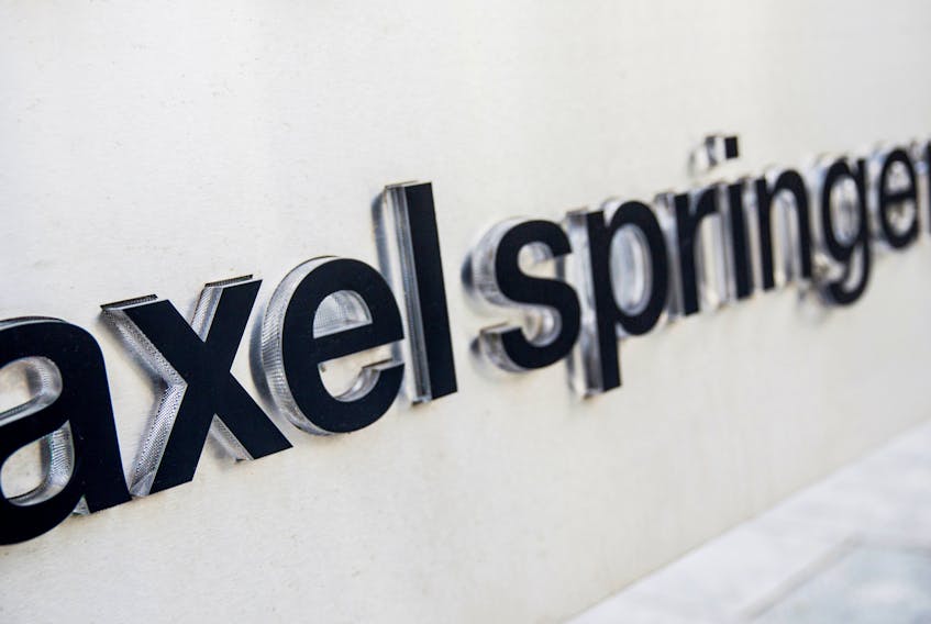 The logo of the German publisher Axel Springer is seen outside its headquarters in Berlin August 7, 2013.  
