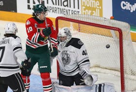 Halifax Mooseheads forward Mathieu Cataford watches a deflected shot go wide in front of Gatineau Olympiques goalie Zach Pelletier during QMJHL action in Halifax on Friday.