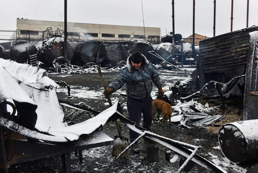 A man inspects damage at an oil depot hit by recent shelling in the course of Russia-Ukraine conflict in Donetsk, Russian-controlled Ukraine, December 7, 2023.