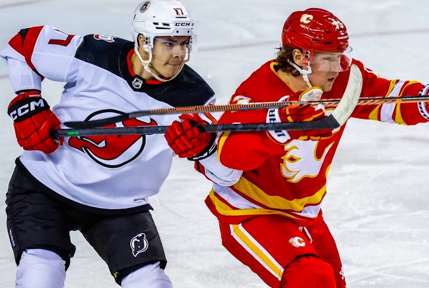 Yegor Sharangovich battles against Tyler Toffoli during NHL hockey at the Scotiabank Saddledome in Calgary on Saturday, November 5, 2022.