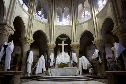 Statues protected by tarpaulins are seen in the choir of the Notre-Dame de Paris Cathedral, which was ravaged by a fire in 2019 that sent its spire crumbling down, as restoration works continue a year before its reopening to the public, in Paris, France, December 8, 2023.