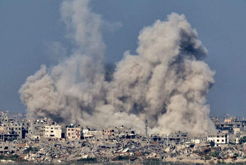 Smoke rises over Gaza, amid the ongoing conflict between Israel and the Palestinian Islamist group Hamas, as seen from southern Israel, December 8, 2023.