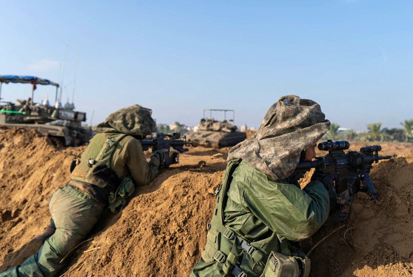 Israeli soldiers operate in the Gaza Strip amid the ongoing conflict between Israel and the Palestinian Islamist group Hamas, in this handout picture released on December 8, 2023. Israel Defense Forces/Handout via REUTERS