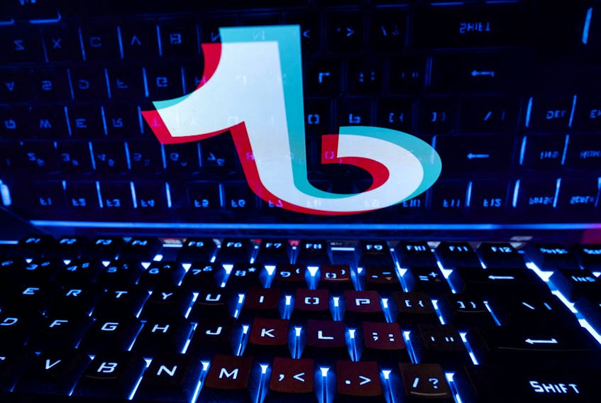 A keyboard is placed in front of a displayed TikTok logo in this illustration taken February 21, 2023.