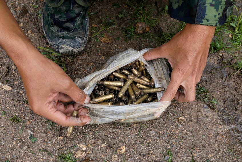 A member of the People's Defence Force (PDF) holds a bag of bullet cases at a training camp in an area controlled by ethnic Karen rebels, Karen State, Myanmar, September 12, 2021. 