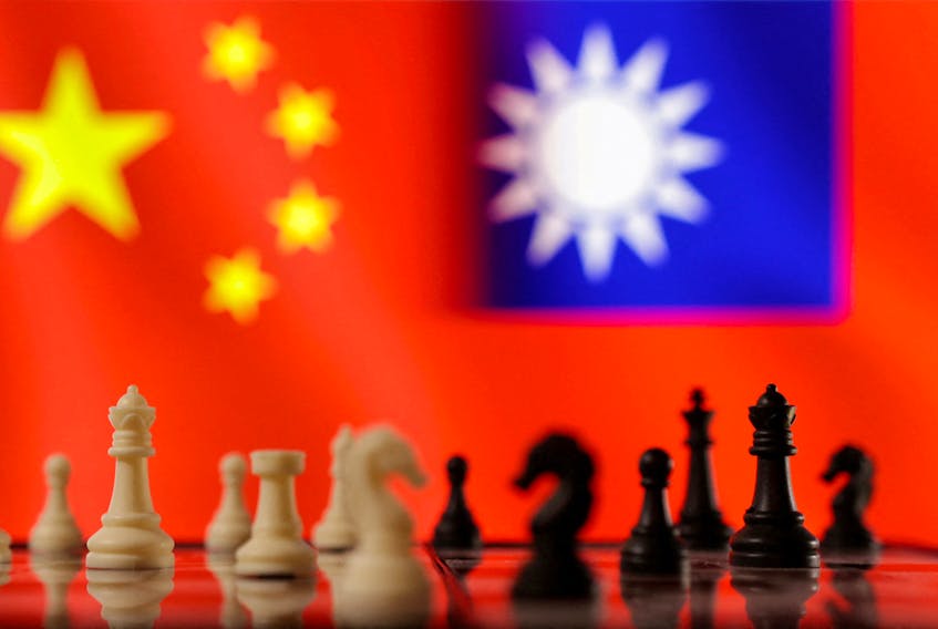 Chess pieces are seen in front of displayed Chinese and Taiwanese flags in this illustration taken, April 11, 2023.