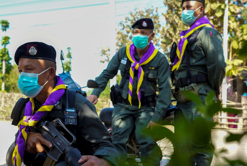 Border police officers observe as they guard near the Thailand-Myanmar border where the fighting between the Myanmar army and ethnic minority rebels still continues in Mae Sot district, Tak province, Thailand, December 19, 2021.