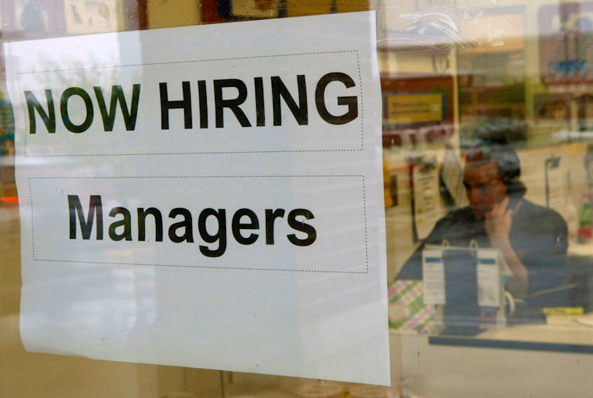A hiring sign hangs in a window at PETCO in Falls Church, Virginia June 5, 2009.  
