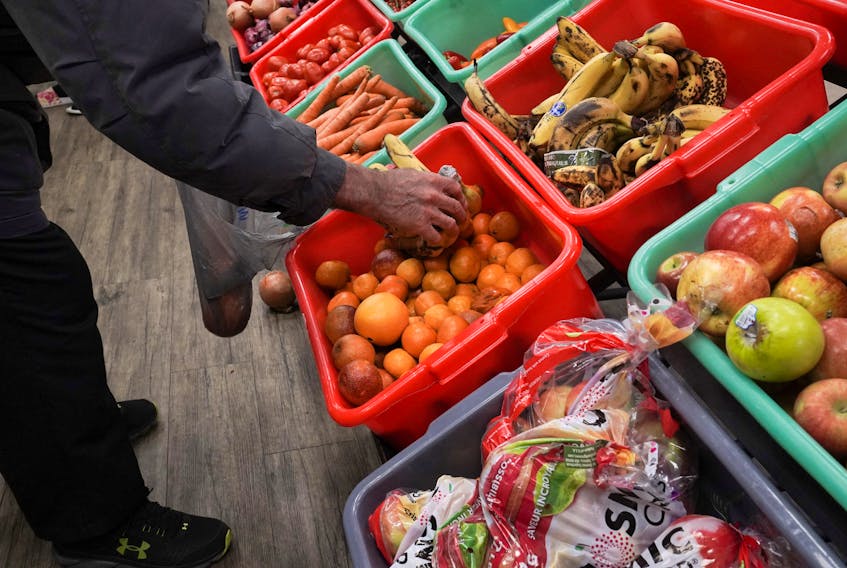A community member grabs a piece of fruit at The Community Assistance Center food pantry, in Atlanta, Georgia, U.S. April 12, 2023. 