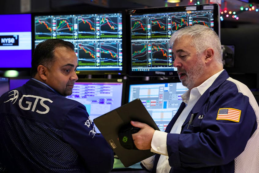 Traders work on the floor at the New York Stock Exchange (NYSE) in New York City, U.S., December 7, 2023. 
