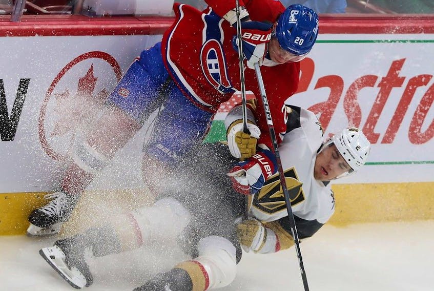 Canadiens' Juraj Slafkovsky (20) brings down Vegas Golden Knights' Zach Whitecloud (2) in Montreal on Nov. 16, 2023.