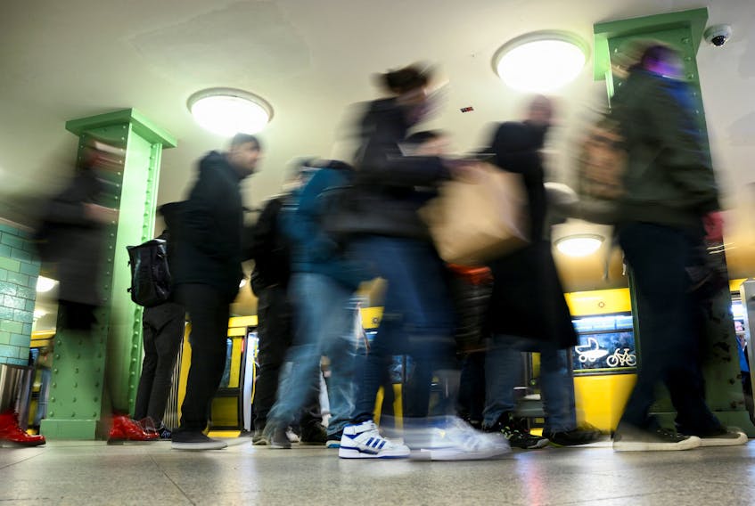 Commuters walk on a Berlin transport company BVG subway platform at Alexanderplatz station during a nationwide strike called by the German trade union Verdi over a wage dispute, in Berlin, Germany, March 27, 2023.